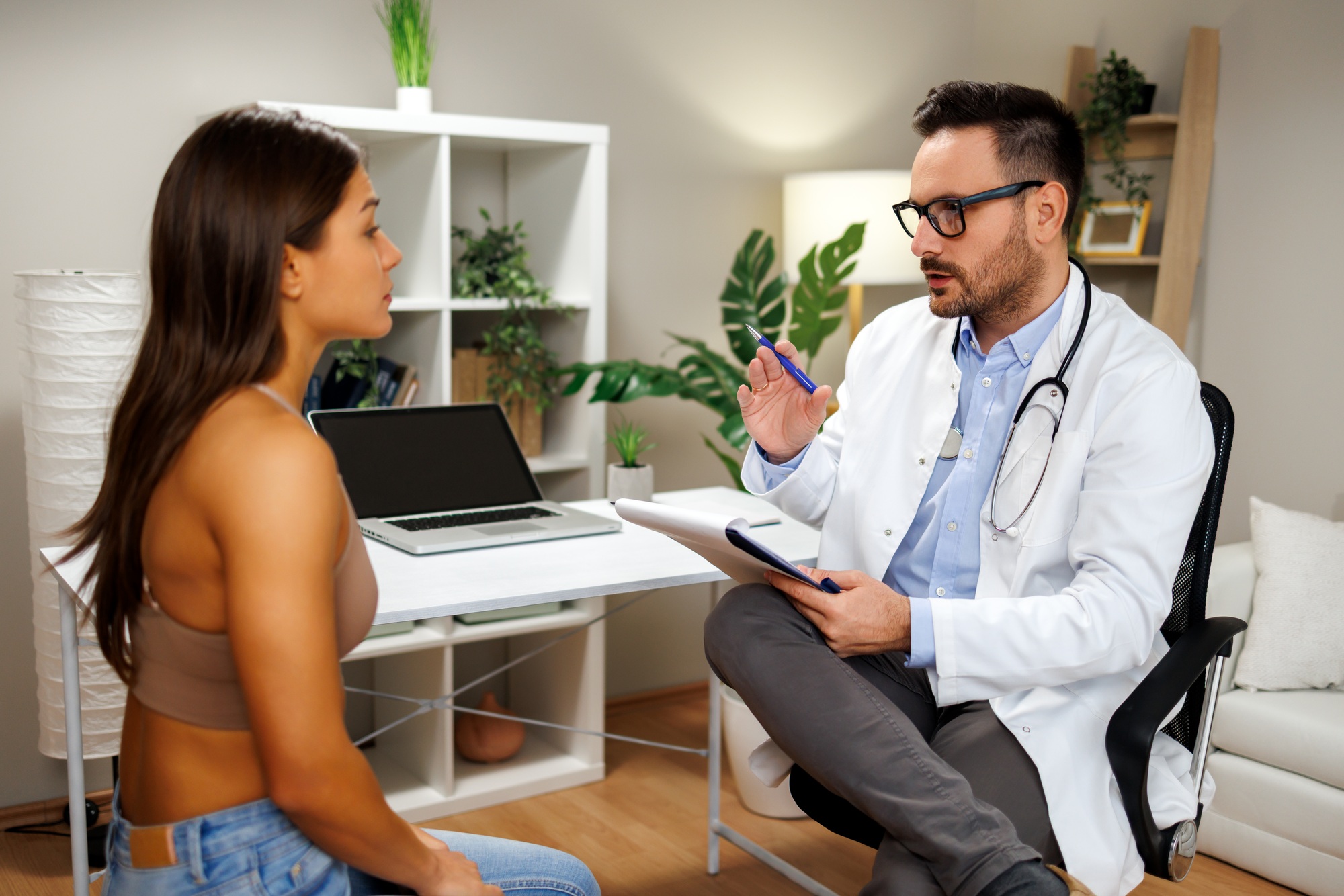 Doctor explaining diagnosis to patient during medical consultation in modern clinic office Doctor explaining diagnosis to patient during medical consultation in modern clinic office