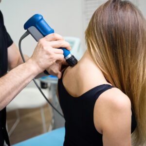 Specialist conducts a shock wave therapy session